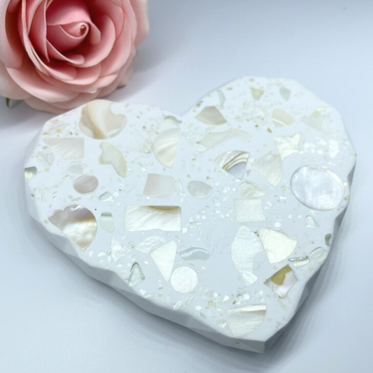 Heart-shaped decorative coaster with mother-of-pearl inlay on a light gray background