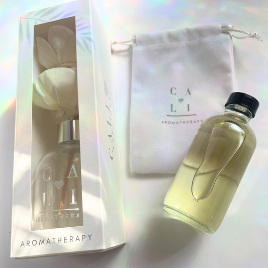 Cali Love Aromatherapy product with packaging on a reflective surface