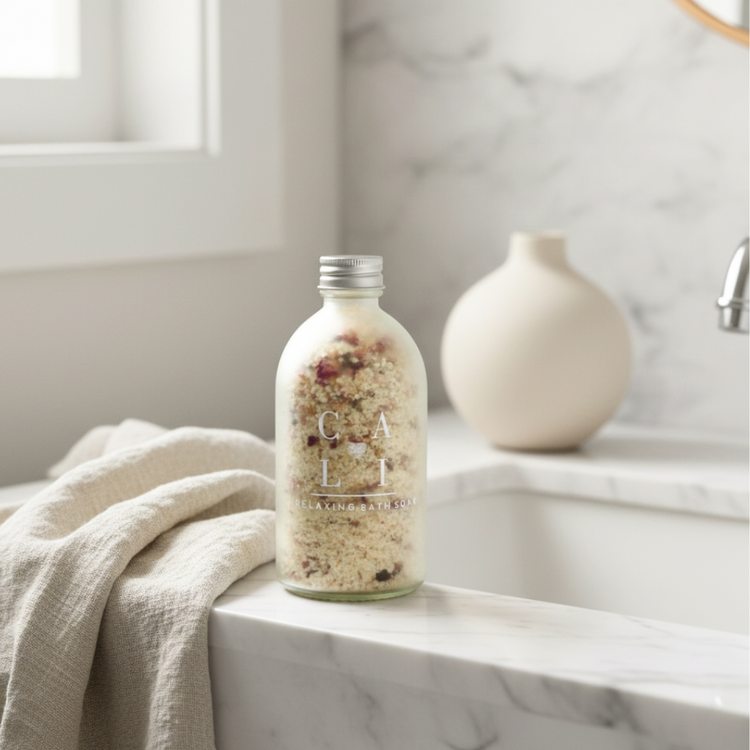 coconut milk bath soak on a marble tub and linen cloth next to it