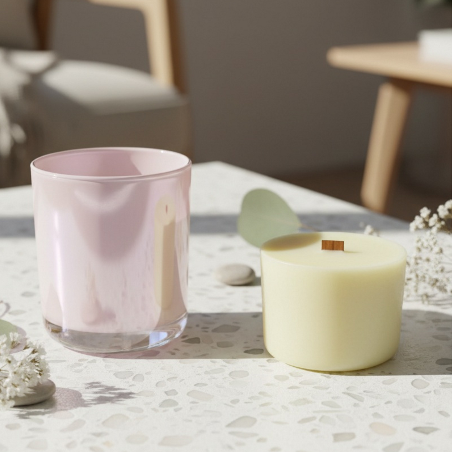 Pink glass and candle refill on a textured surface with blurred background